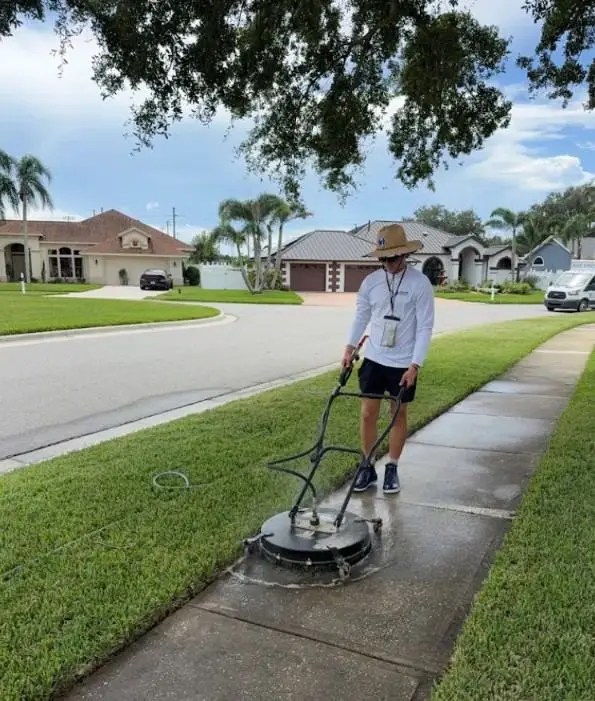 Technician surface cleaning a neighborhood sidewalk in Melbourne, FL