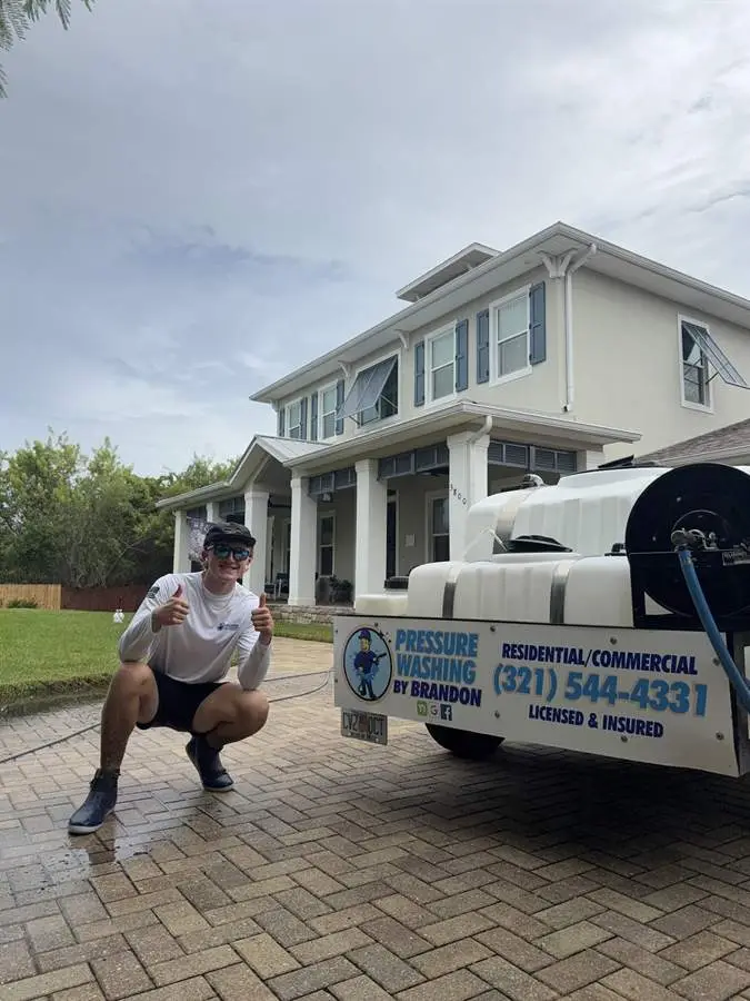 Pressure Washing by Brandon crew member with the wash trailer at a Rockledge, FL home