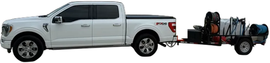Pressure Washing by Brandon pickup truck towing its pressure washing trailer