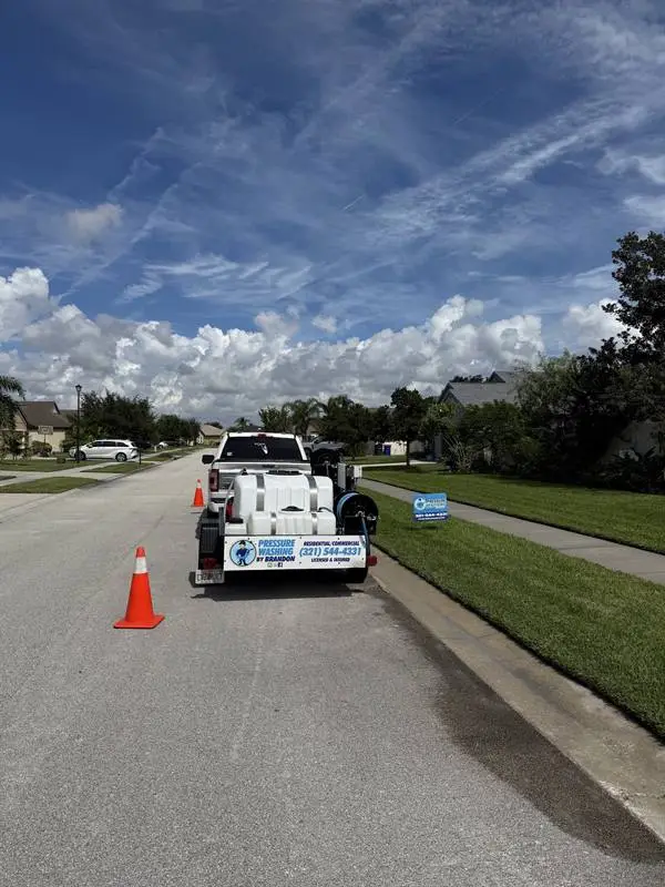 Pressure washing service truck and trailer set up on a Rockledge, FL street