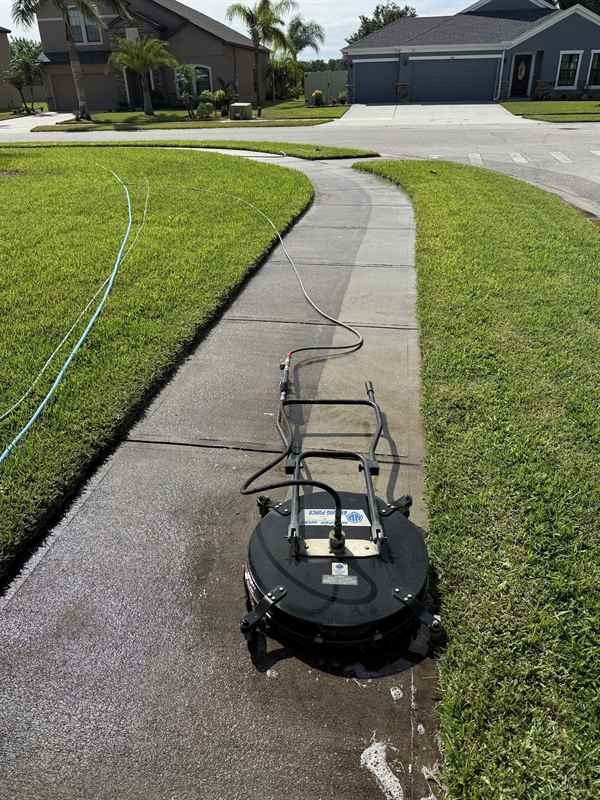 Surface cleaner on a sidewalk between green lawns in Rockledge, FL